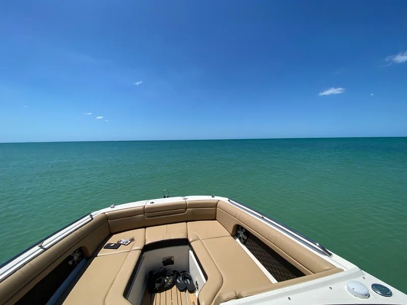 Bow of a boat cutting across open Gulf water